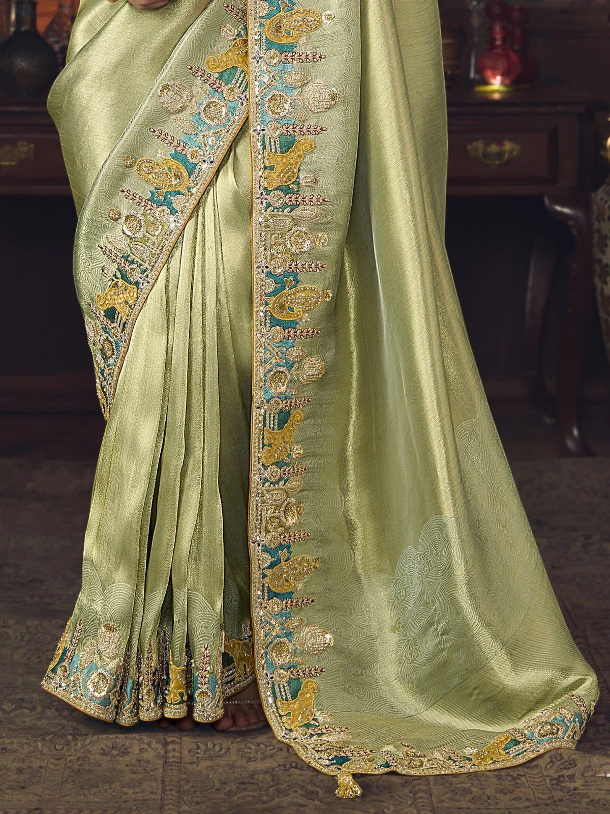 Tarani green silk saree pallu with heavy zari border and traditional motifs for festive wear