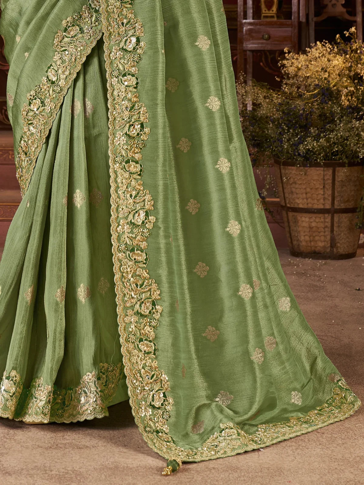Tarani premium silk saree pallu view in green with zari border and hanging latkan detailing