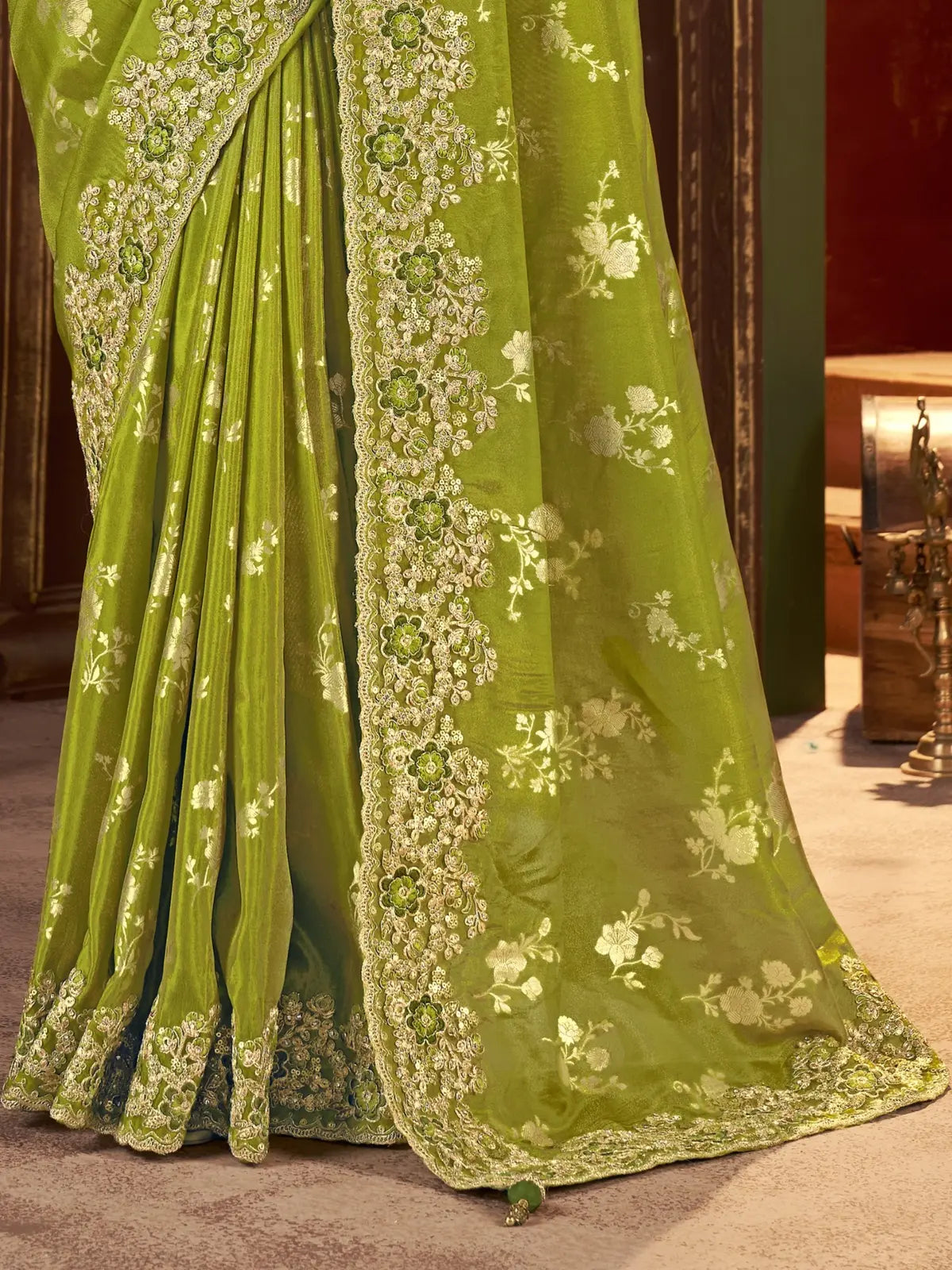 Tarani pallu view of green silk saree with zari embroidery border and latkan