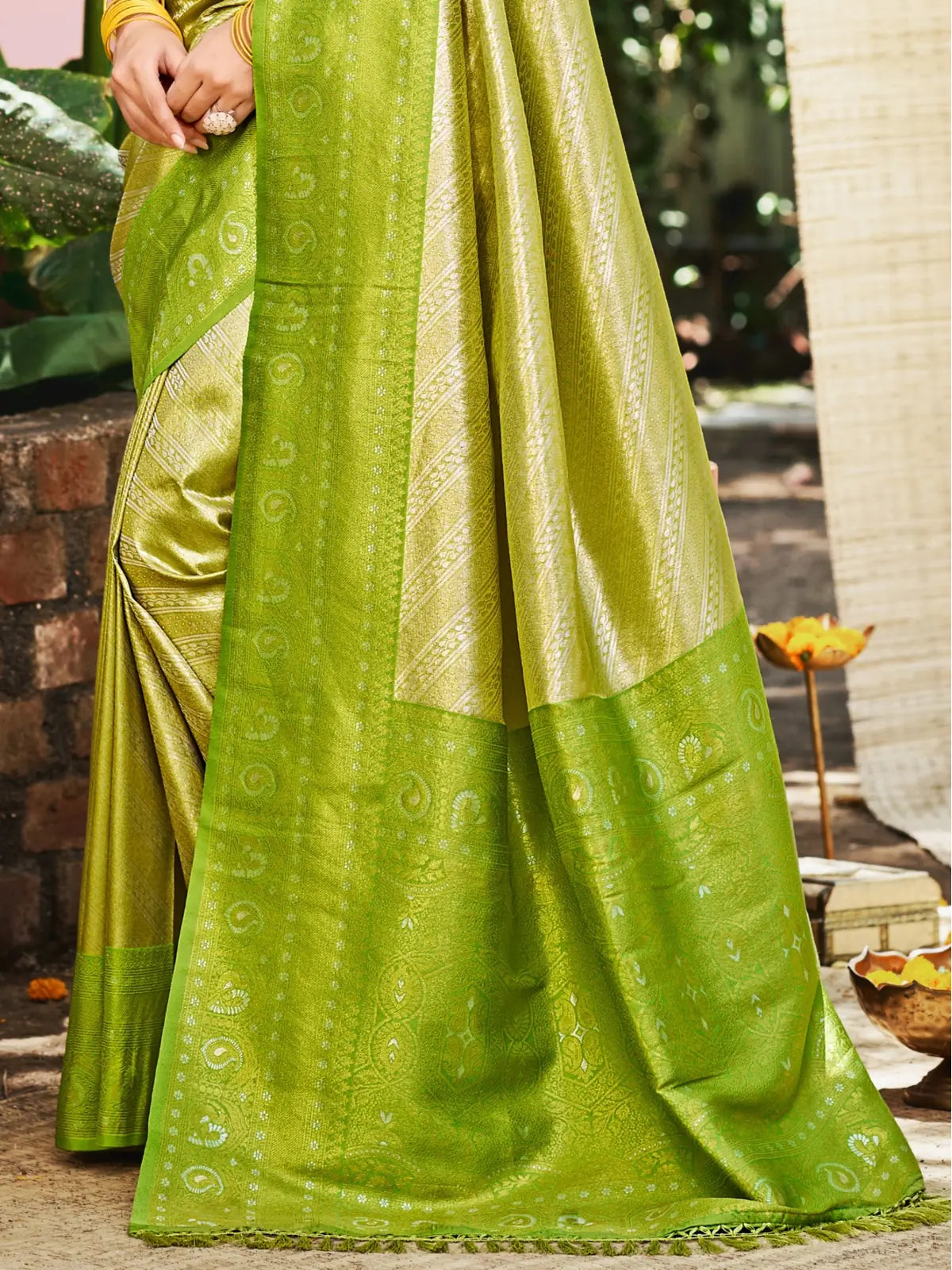 Tarani pallu view of green Kanjivaram silk saree with traditional woven border and rich detailing