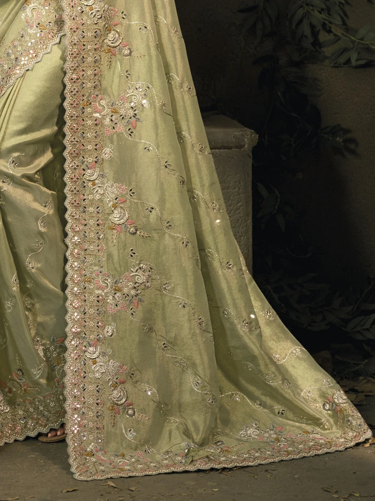 Tarani green silk saree closeup pallu view with shimmering mirror embroidery work for festive events