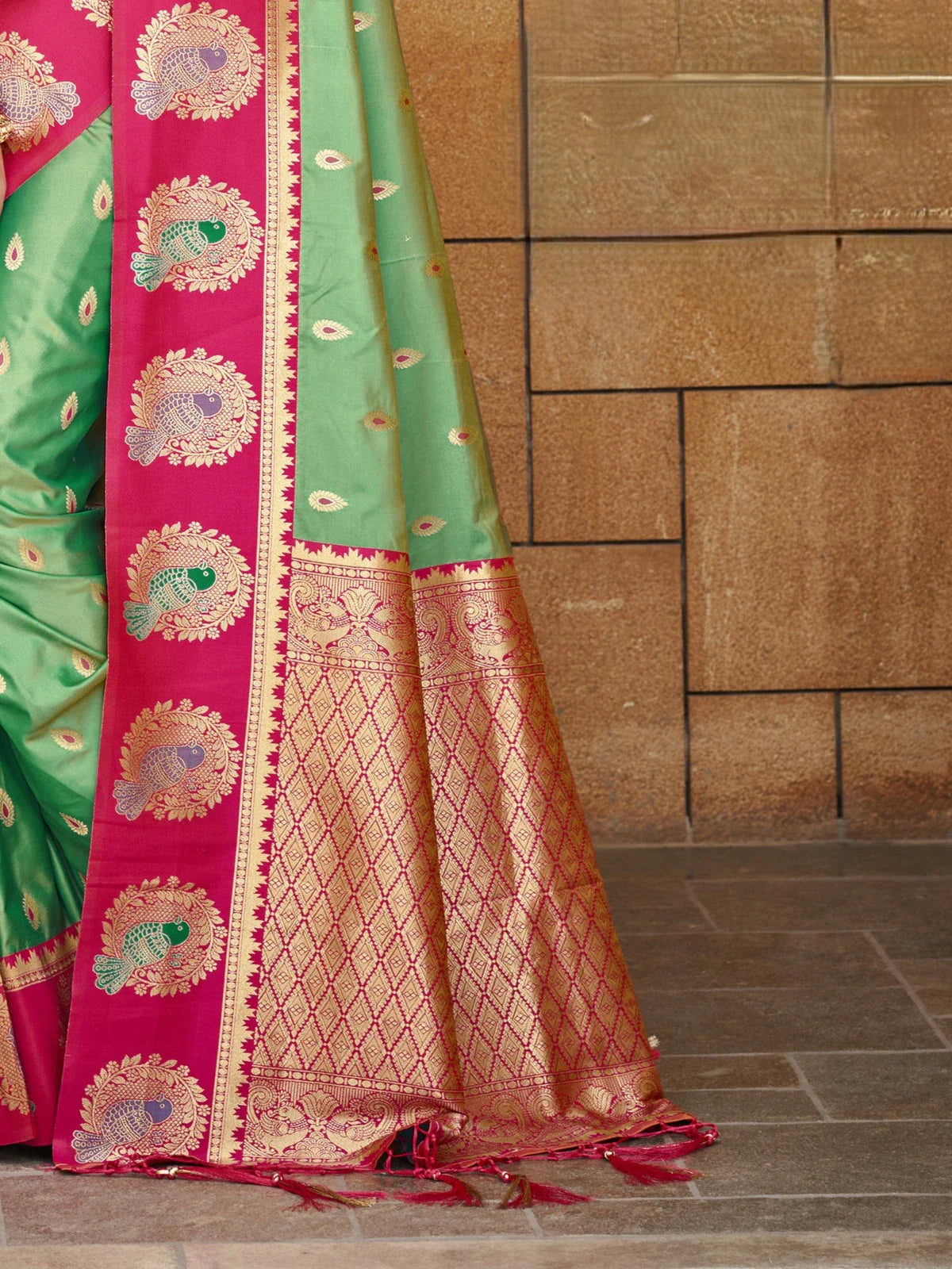 Tarani rich green silk saree with woven golden pallu and intricate border closeup