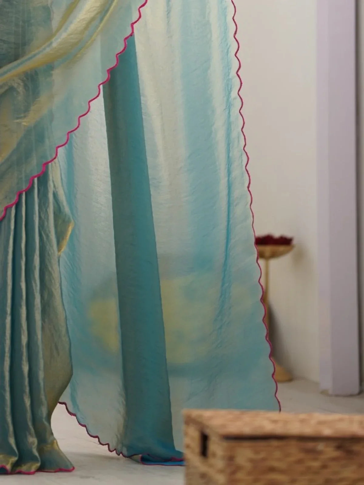 Tarani green space silk saree pallu view with magenta scalloped edging in natural light