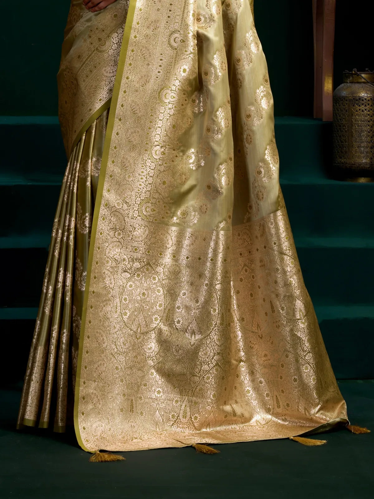 Tarani satin silk saree in green showing detailed zari pallu with tassels
