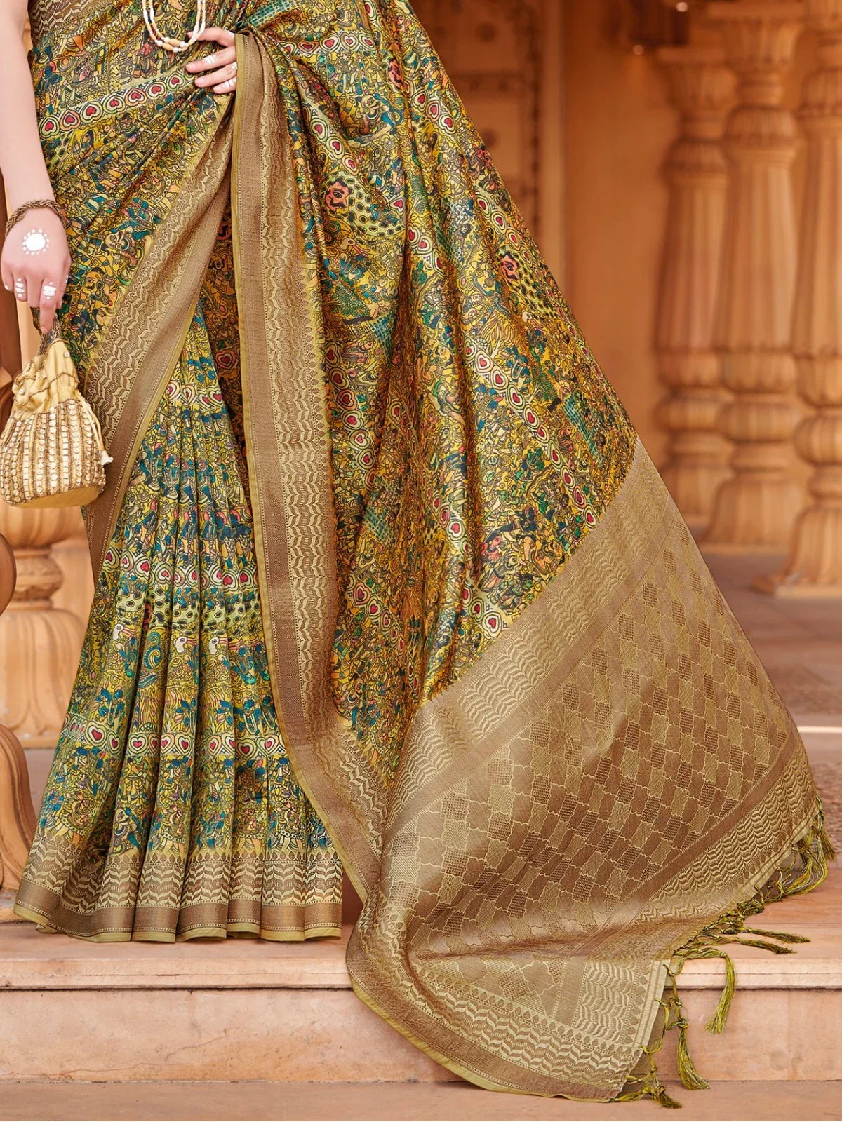 Tarani green silk saree pallu view highlighting woven patterns and gold accents