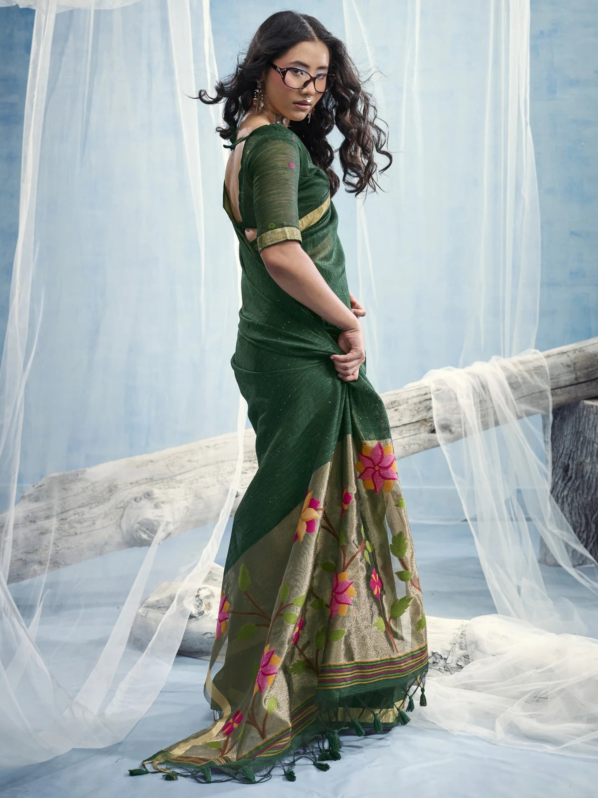 Tarani Tanisha green Munga silk saree side view with floral tissue pallu and tassel finish