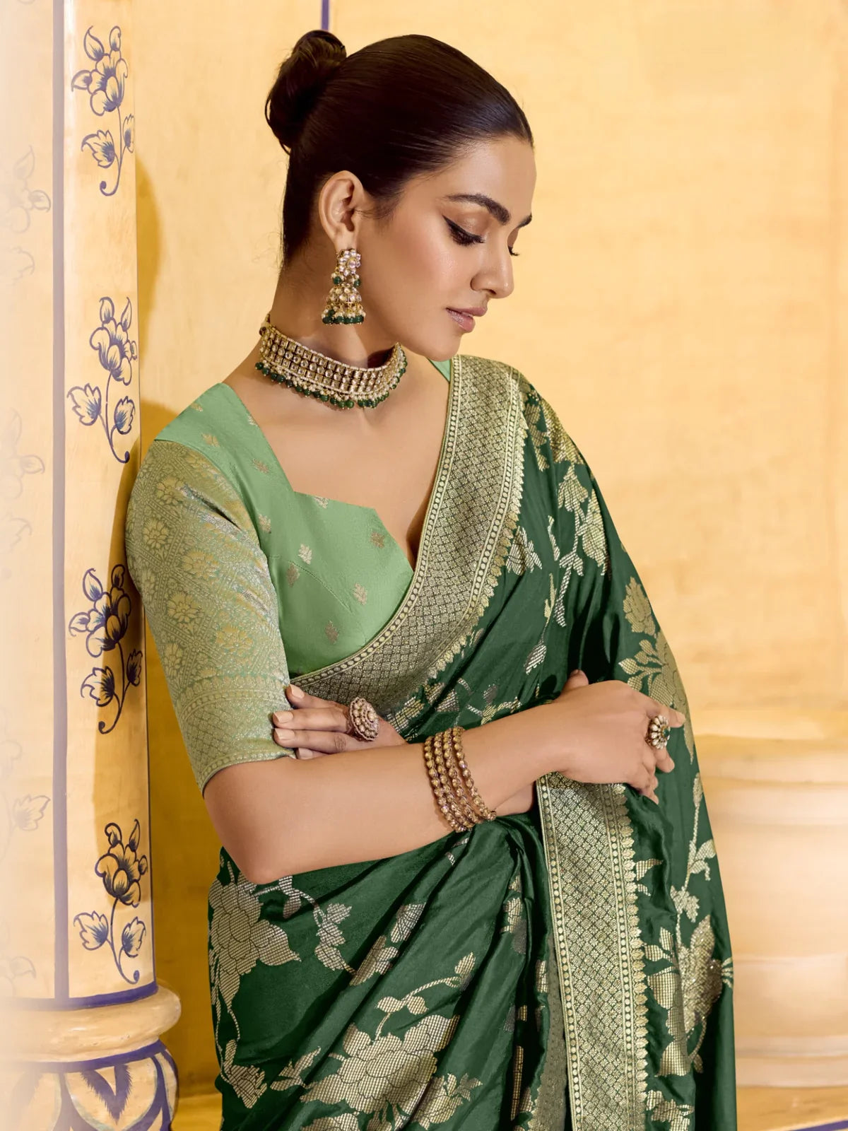 Close-up of Tarani green silk saree with zari woven floral pattern and gold border detailing