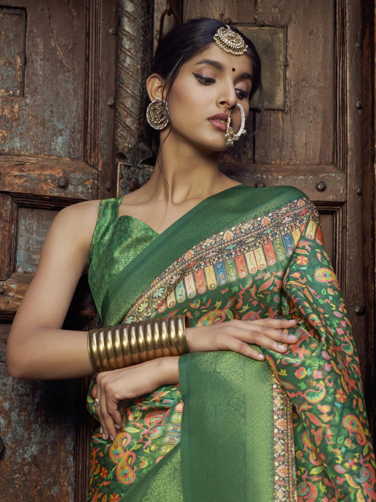 Tarani saree closeup showing green pallu and blouse with floral zari weave for festive elegance