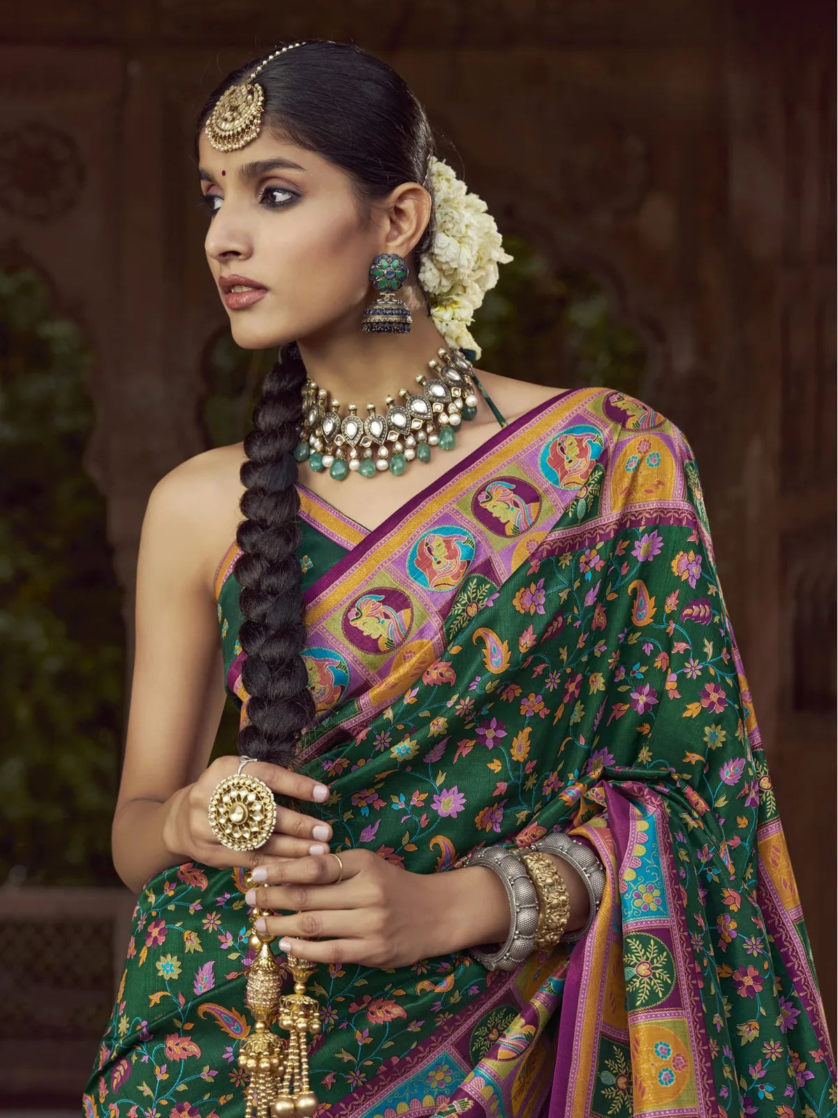 Tarani green silk saree upper body view showcasing elegant print and traditional jewelry