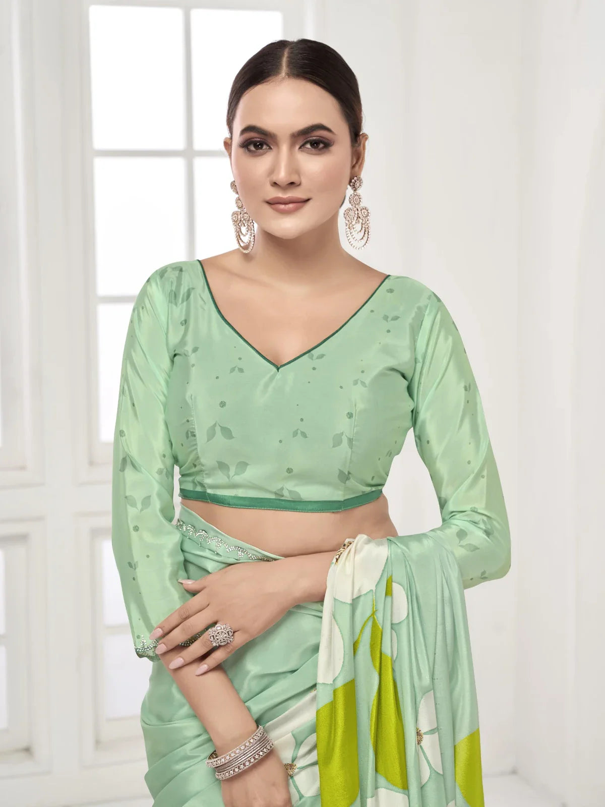 Tarani digital silk saree in green shade with elegant blouse work shown in upper body pose
