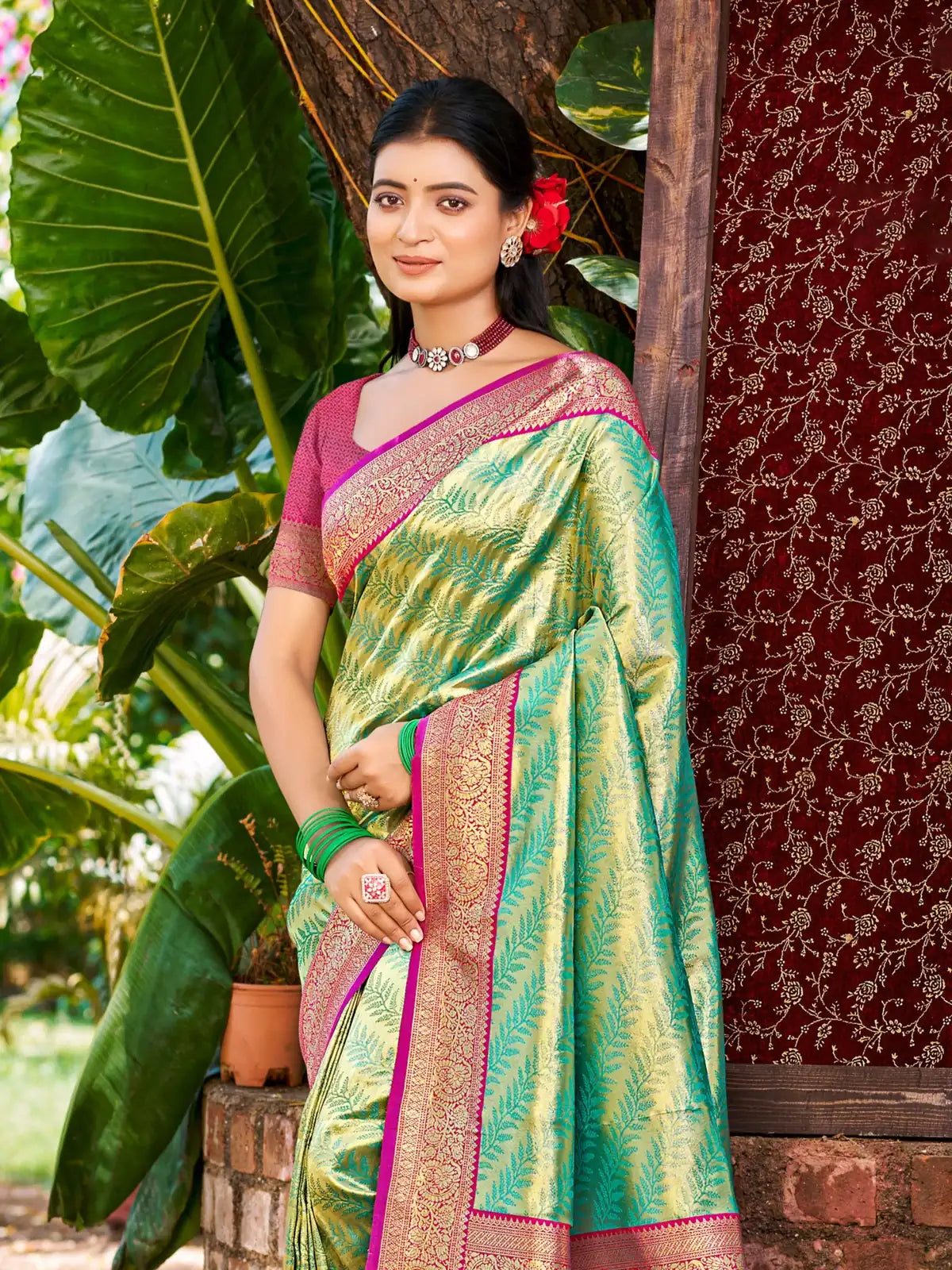 Tarani premium Kanjivaram silk saree upper body view with pink border and green drape