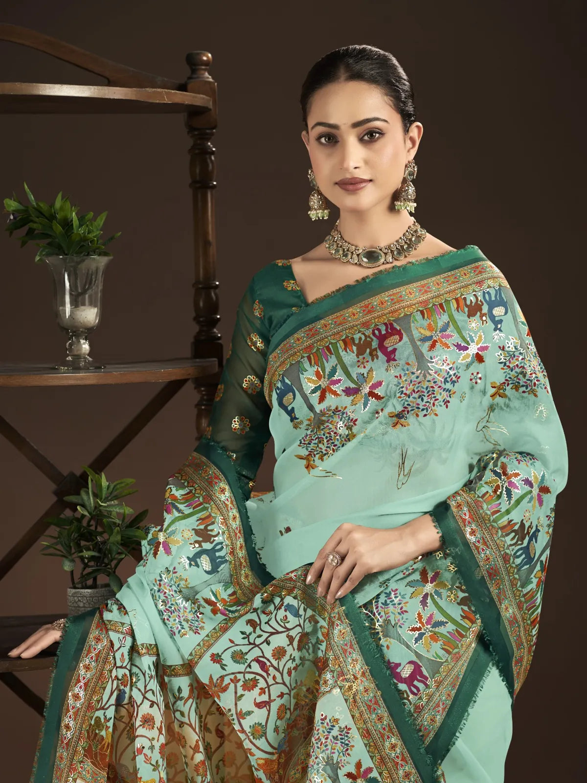 Tarani premium green silk saree with detailed neckline and contrast blouse in upper body view