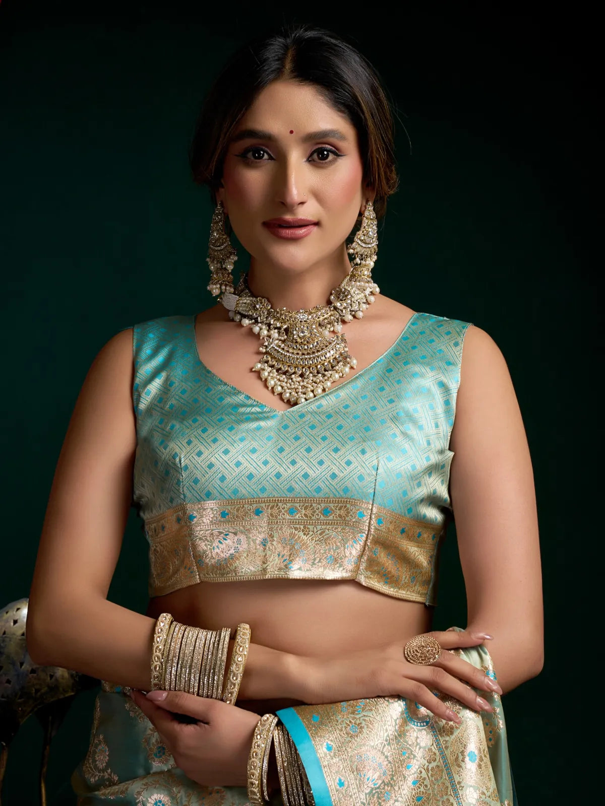 Tarani green satin silk saree close-up view of matching blouse with ethnic jewellery