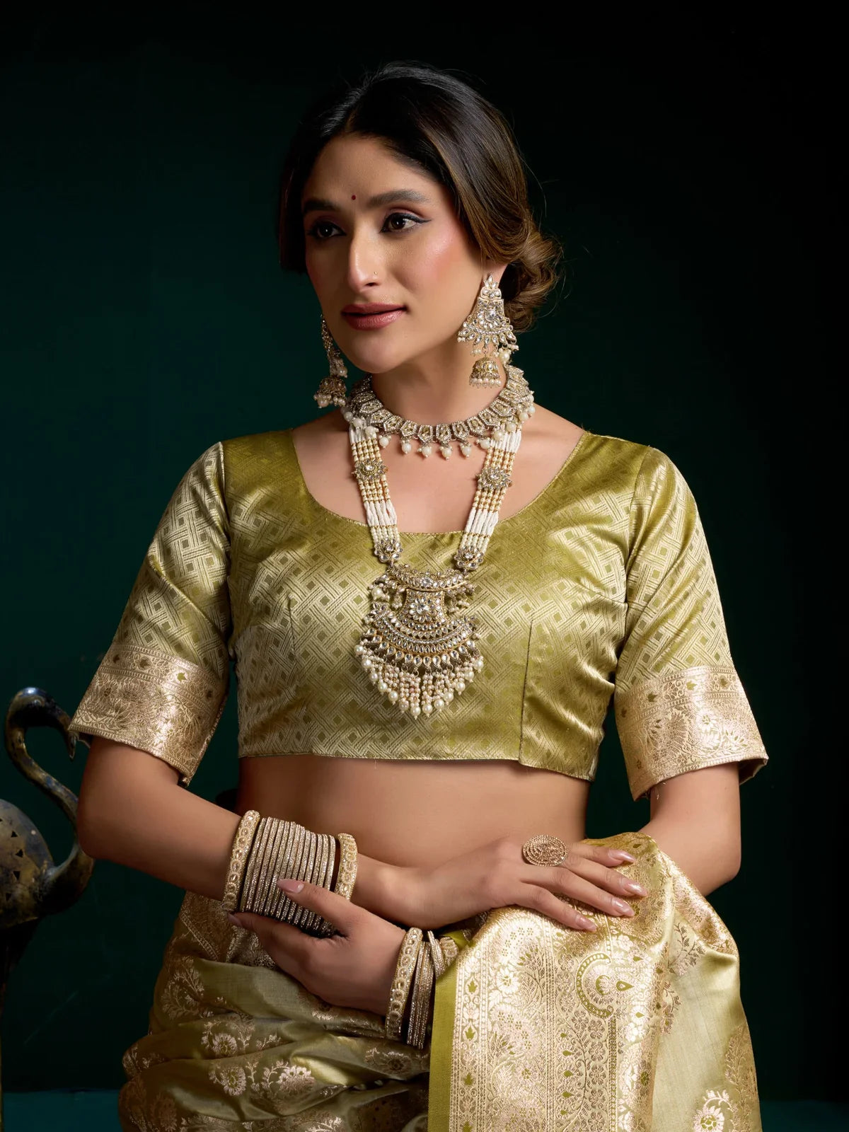 Tarani green satin silk saree close-up showing blouse design and model jewellery