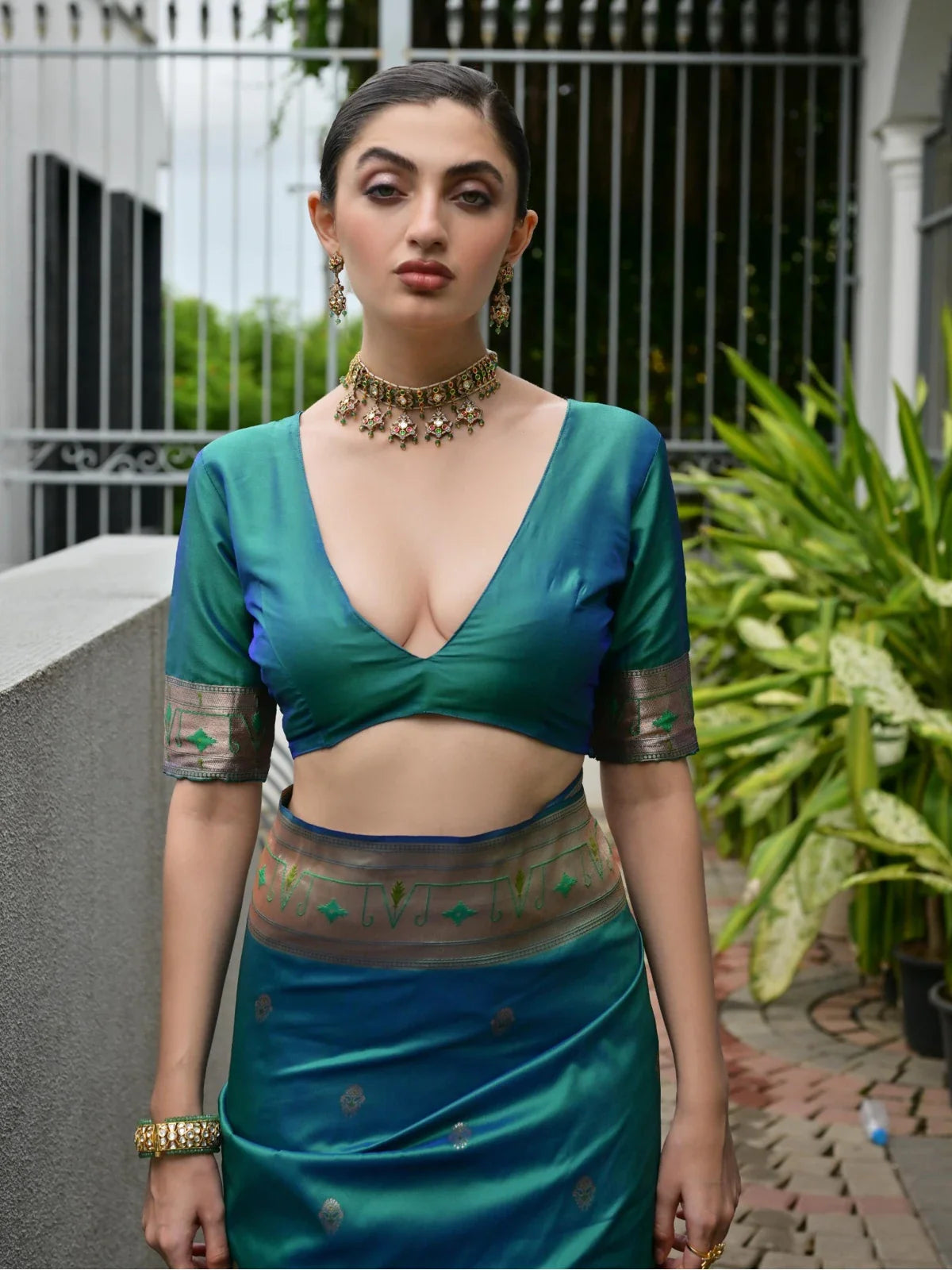 Tarani premium green saree blouse close-up with zari border and traditional neckline