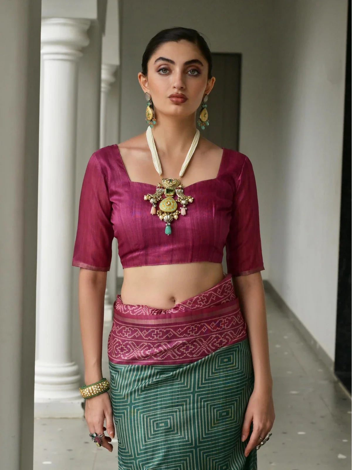 Tarani tussar silk blouse in wine with squared neckline paired with green saree