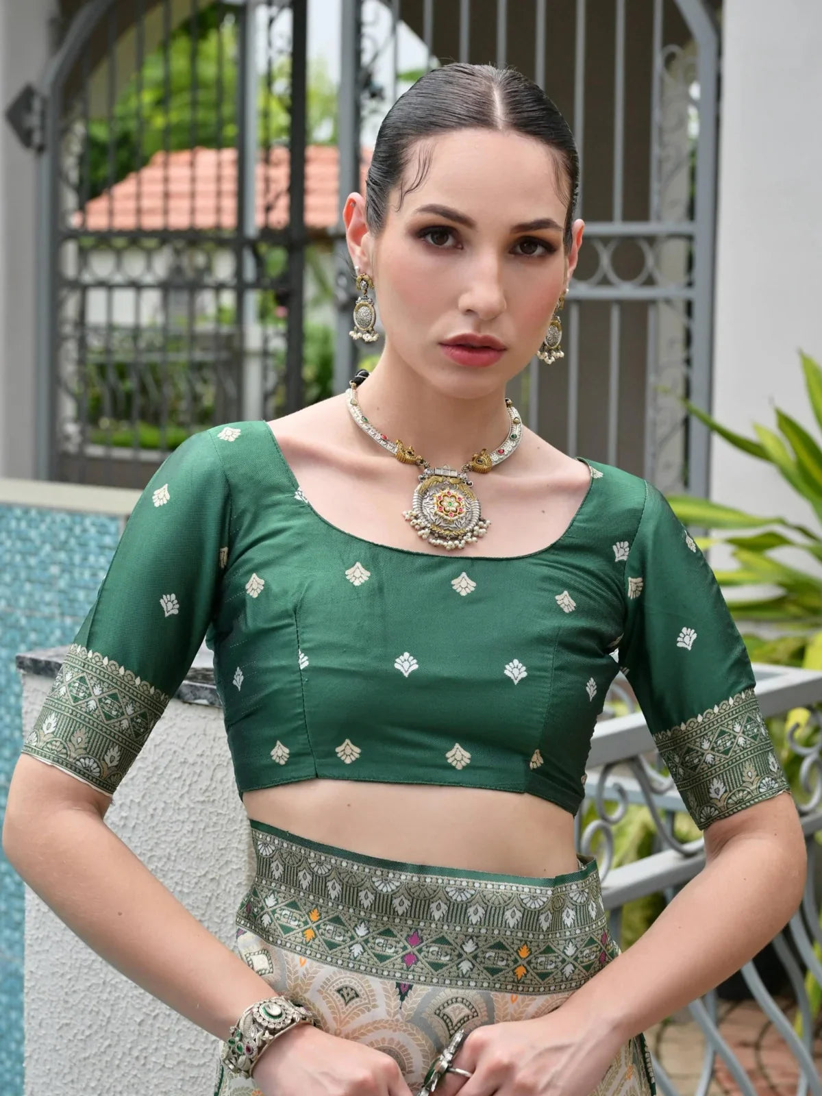 Tarani green silk saree blouse closeup with traditional design and back tassel