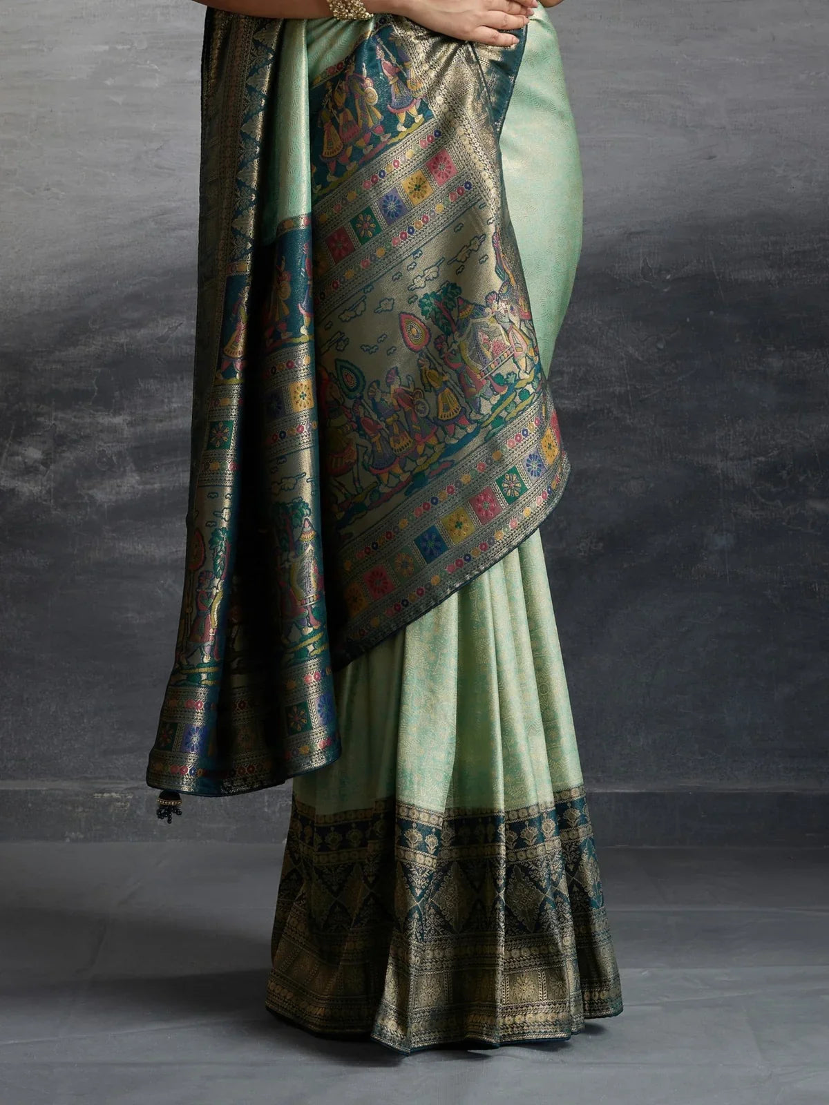 Tarani green silk saree pallu closeup with meenakari weaving and zari border