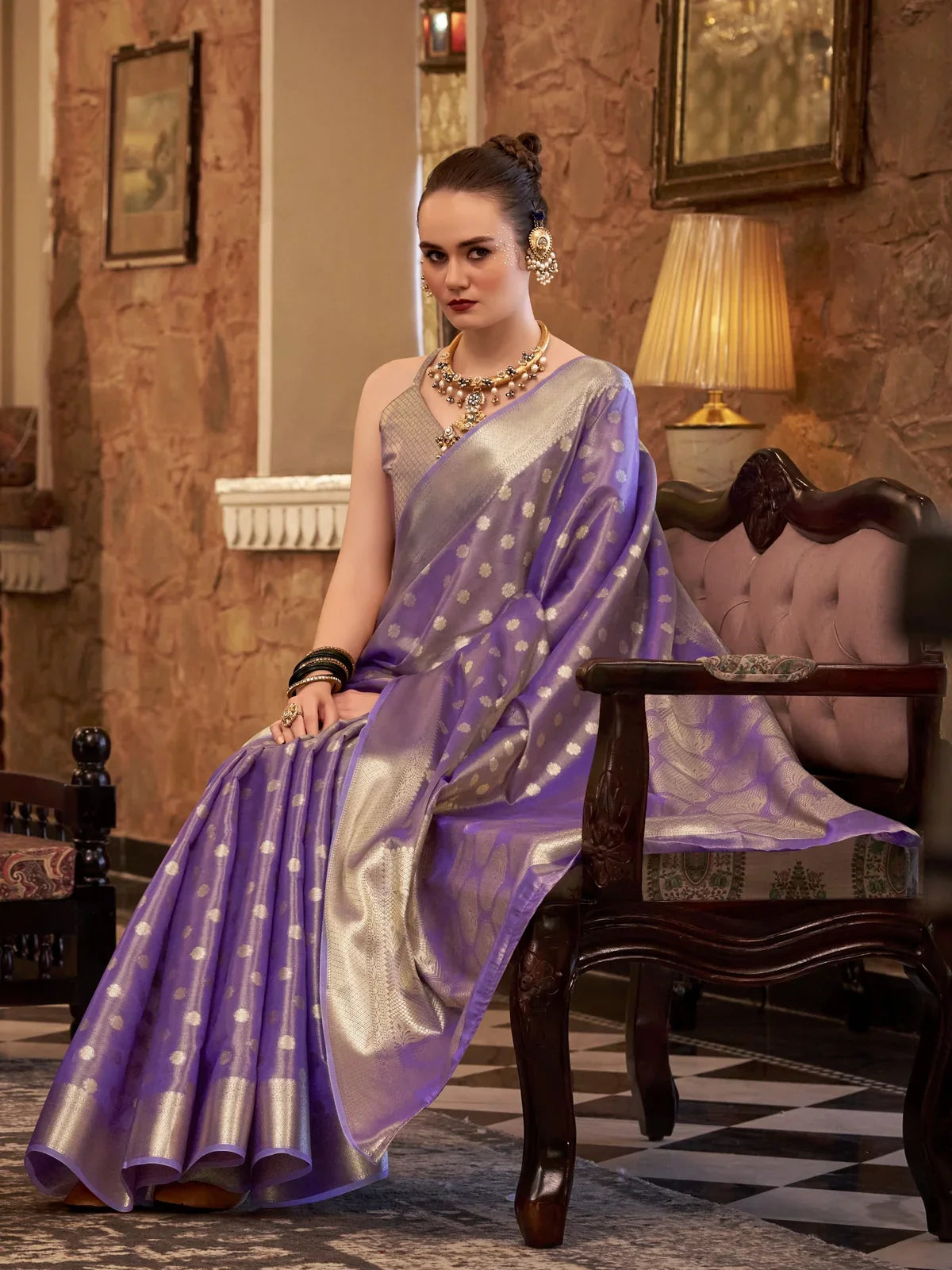 Tarani lavender zari tissue silk saree front seated view with pleats and silver border