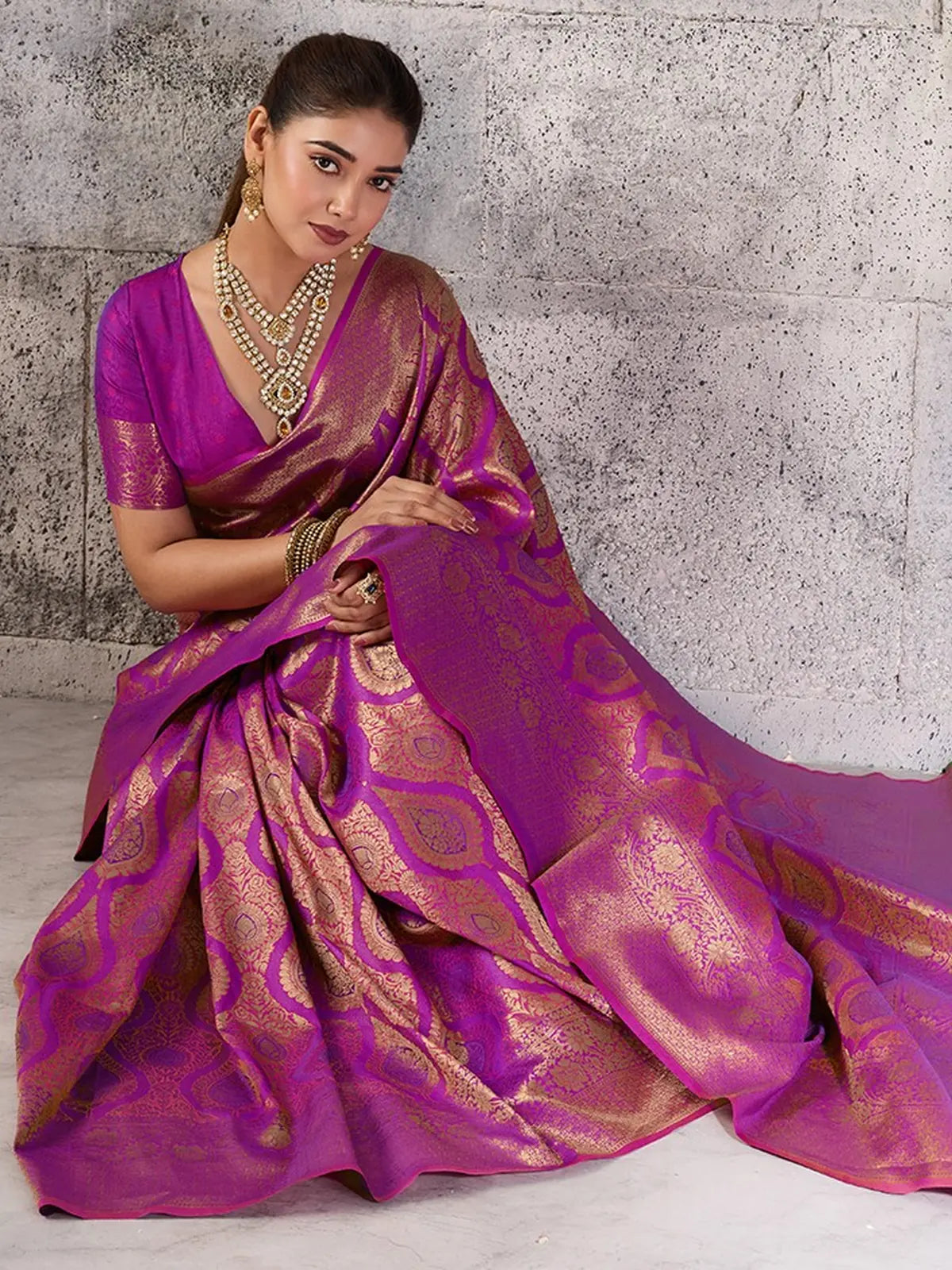 Tarani magenta Kanjivaram silk blend saree seated front view with rich zari woven pallu