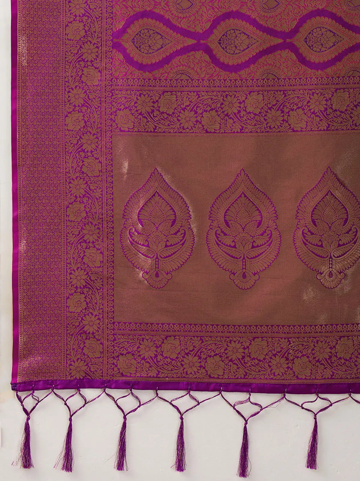Tarani magenta Kanjivaram silk blend saree pallu closeup with gold zari motifs and tassels