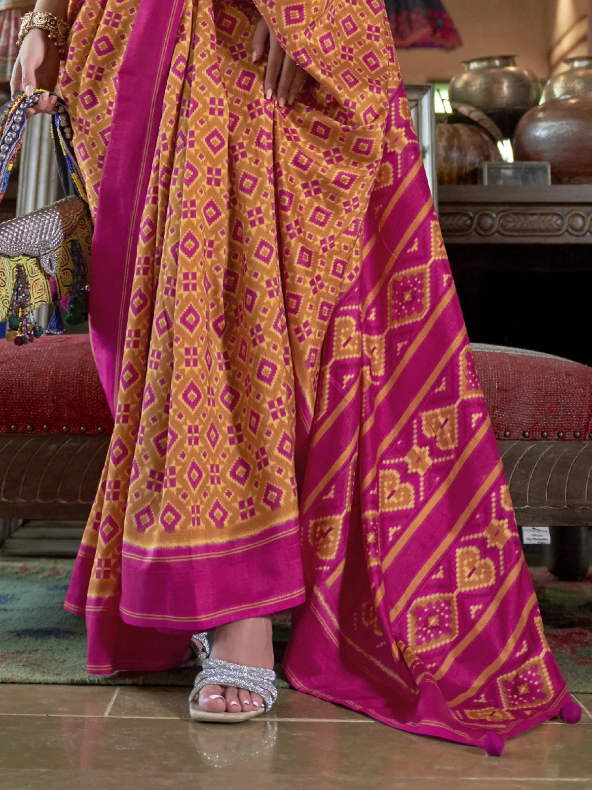 Tarani signature pallu view showing magenta border pattern and geometric ikkat detailing
