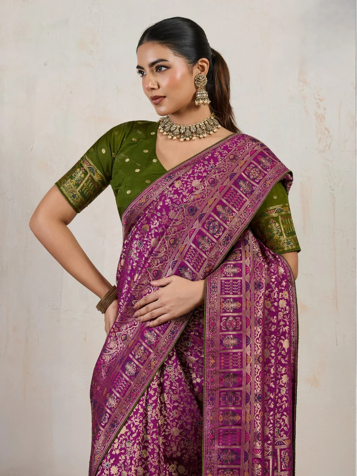 Tarani magenta soft silk saree upper body view with traditional jewellery and blouse detailing