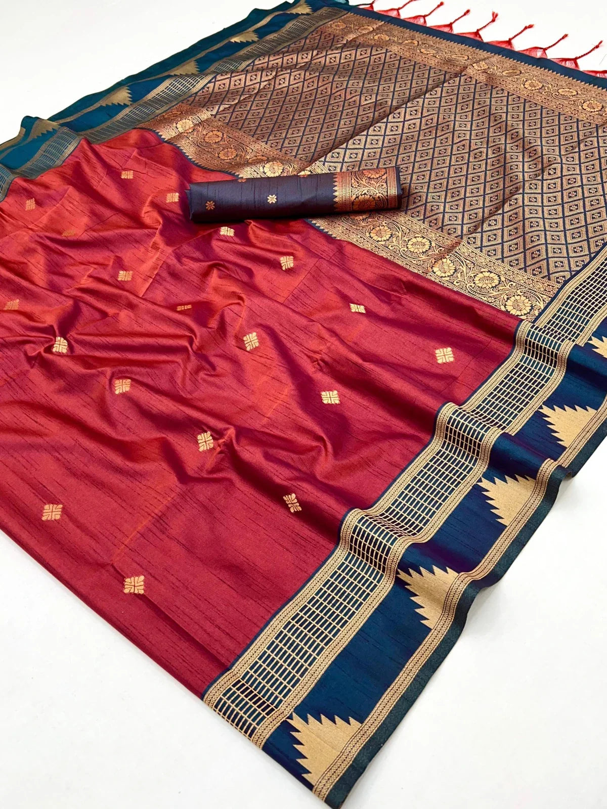 Tarani closeup of maroon silk saree fabric with elegant golden woven motifs