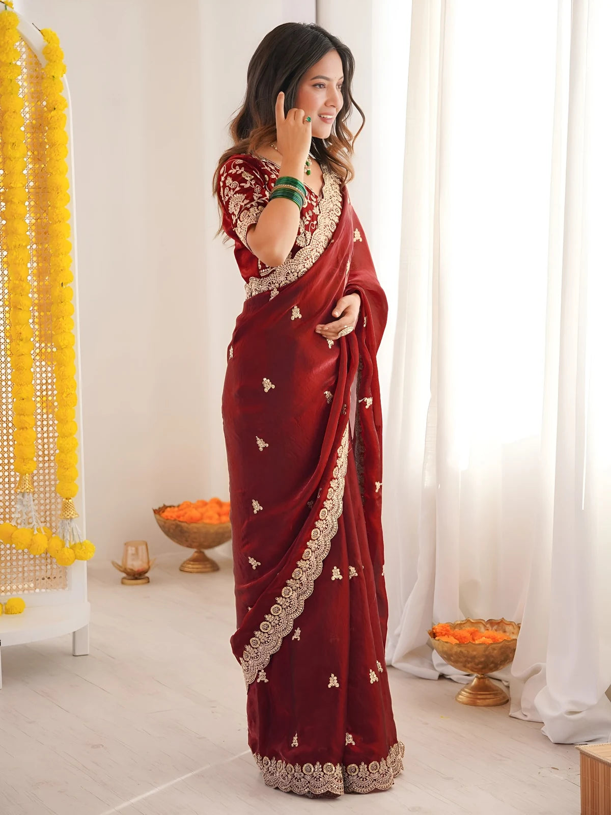 Tarani Mrunmayi maroon party wear saree front pose with designer embroidered blouse
