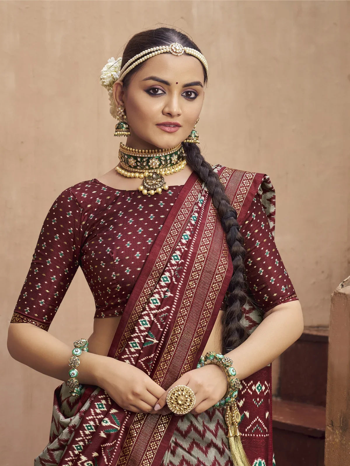 Tarani maroon silk patola saree upper body view showing embroidered blouse and jewelry