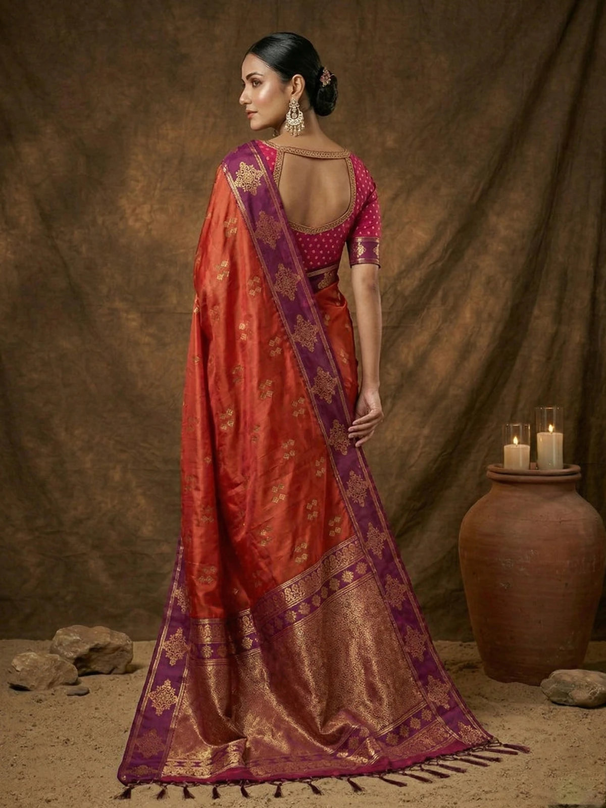 Tarani soft silk orange saree back view with rich zari pallu and traditional woven detailing