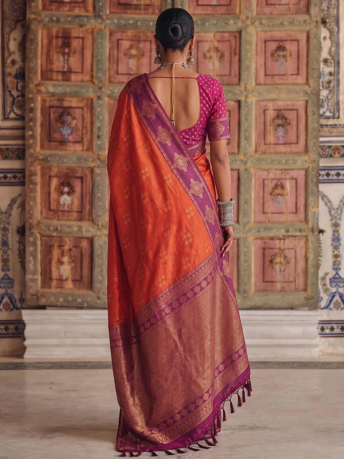 Tarani premium soft silk orange saree with purple woven border back view