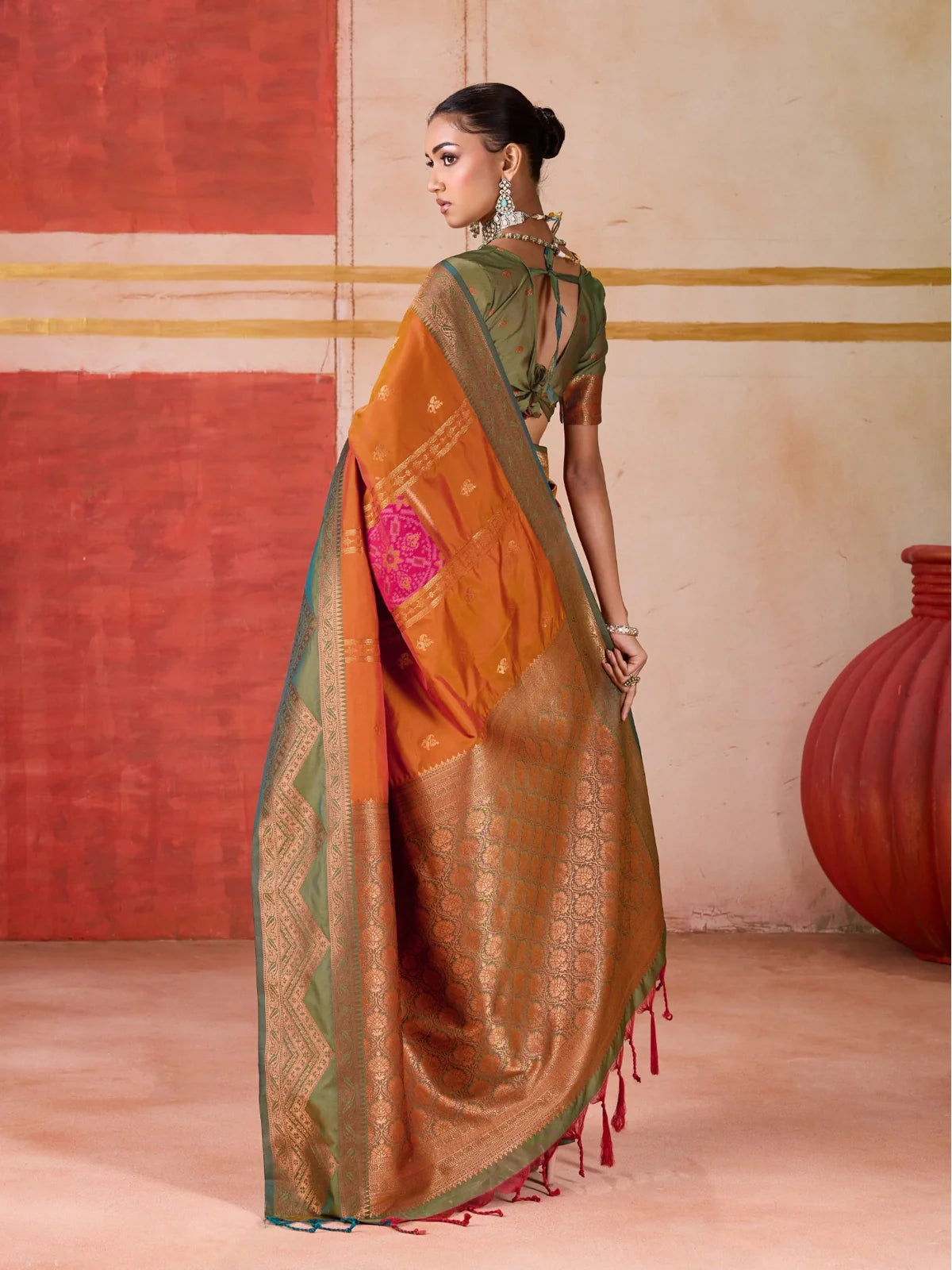 Tarani traditional orange silk saree full back view with pallu drape and blouse tie-up design