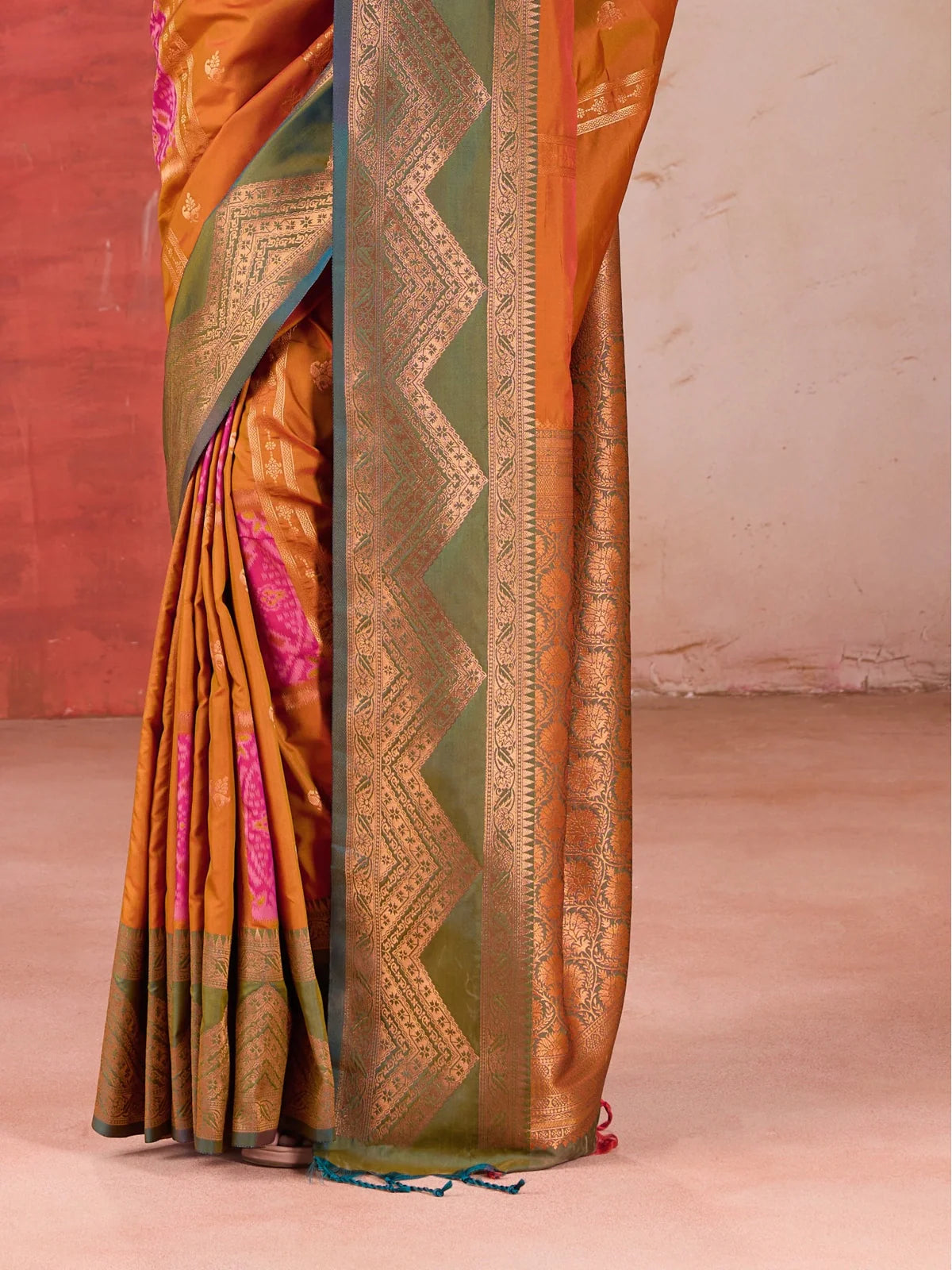 Tarani festive orange silk saree zoomed-in view showing weaving border and pallu detailing