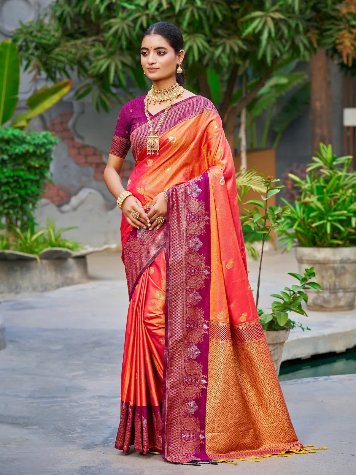 Tarani orange soft silk saree full view with zari woven border and festive handloom elegance