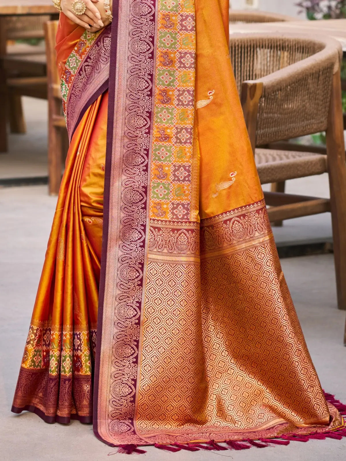 Tarani orange soft silk saree pallu view with rich woven zari border and traditional detailing