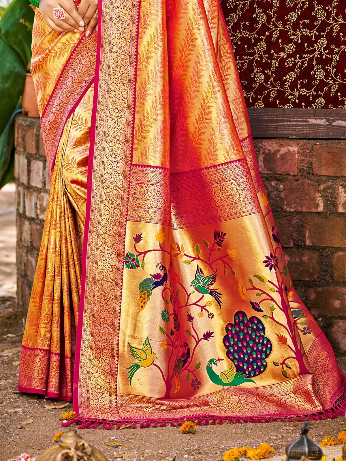 Tarani orange Kanjivaram silk saree pallu closeup view with bird and peacock woven motifs