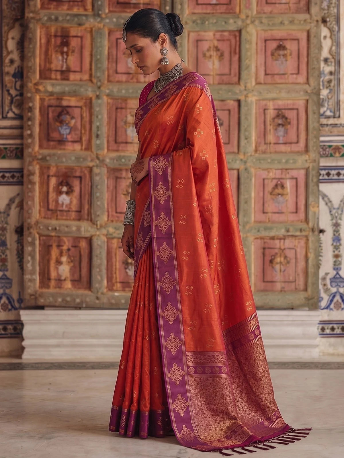 Tarani premium soft silk orange saree with purple woven border side view