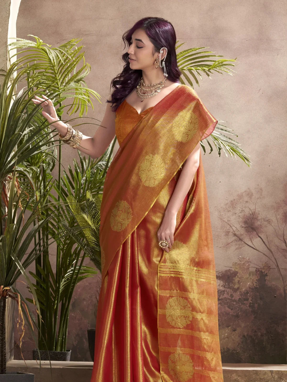 Tarani orange tissue silk saree side profile highlighting woven motifs and drape