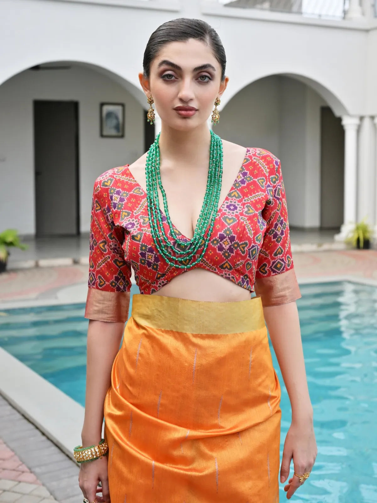 Tarani silk saree orange upper body view showing model wearing ikkat blouse