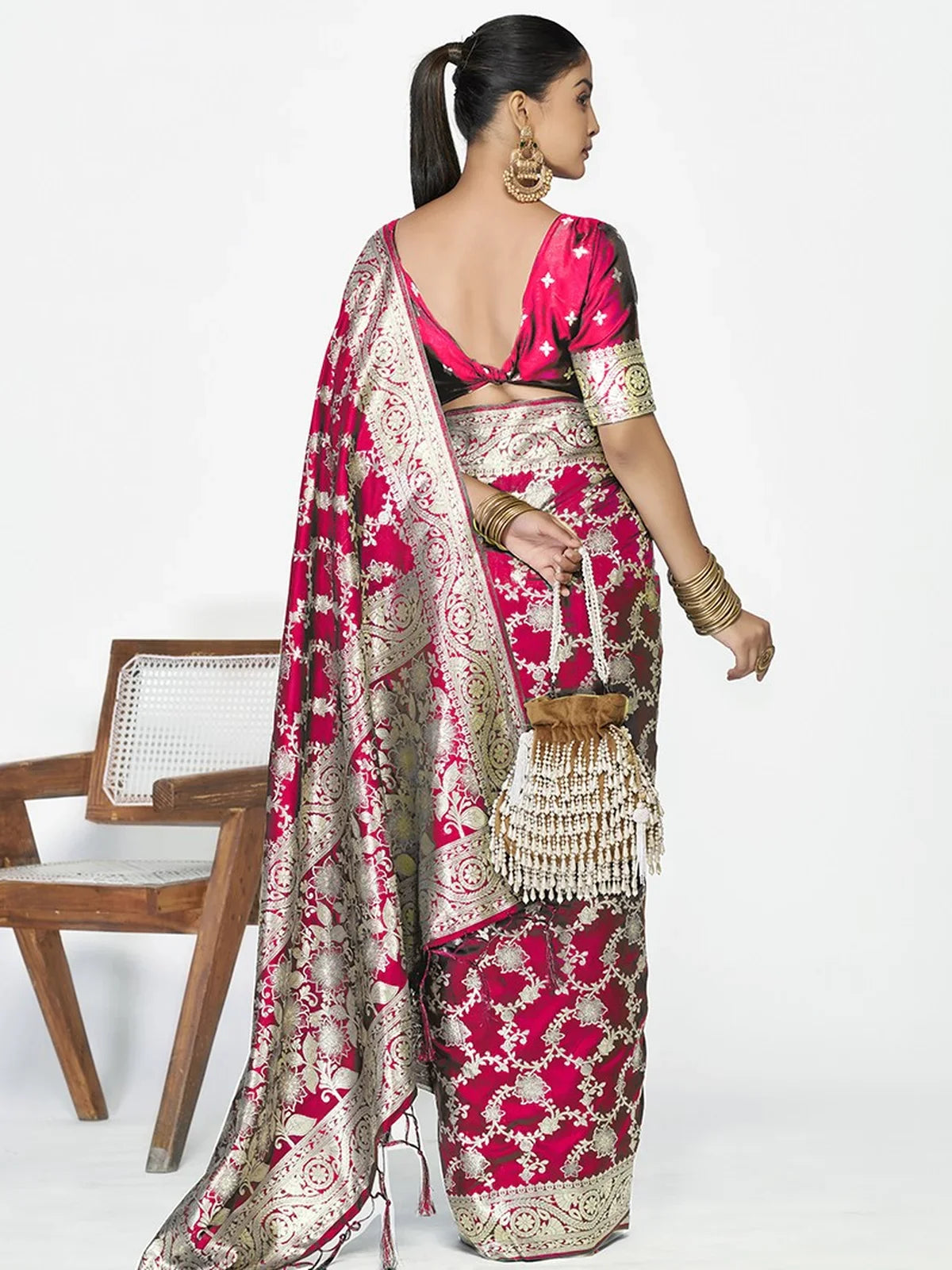 Tarani pink silk saree back view highlighting blouse design and border craftsmanship