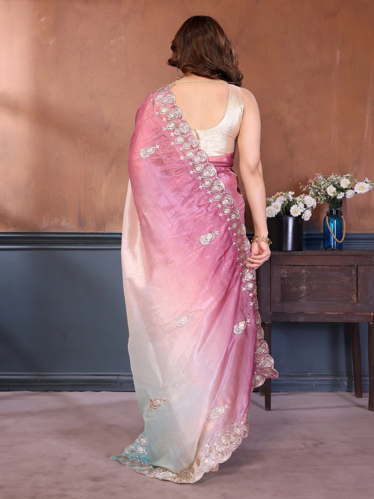 Tarani back view of pink silk saree drape with elegant embroidery for party look