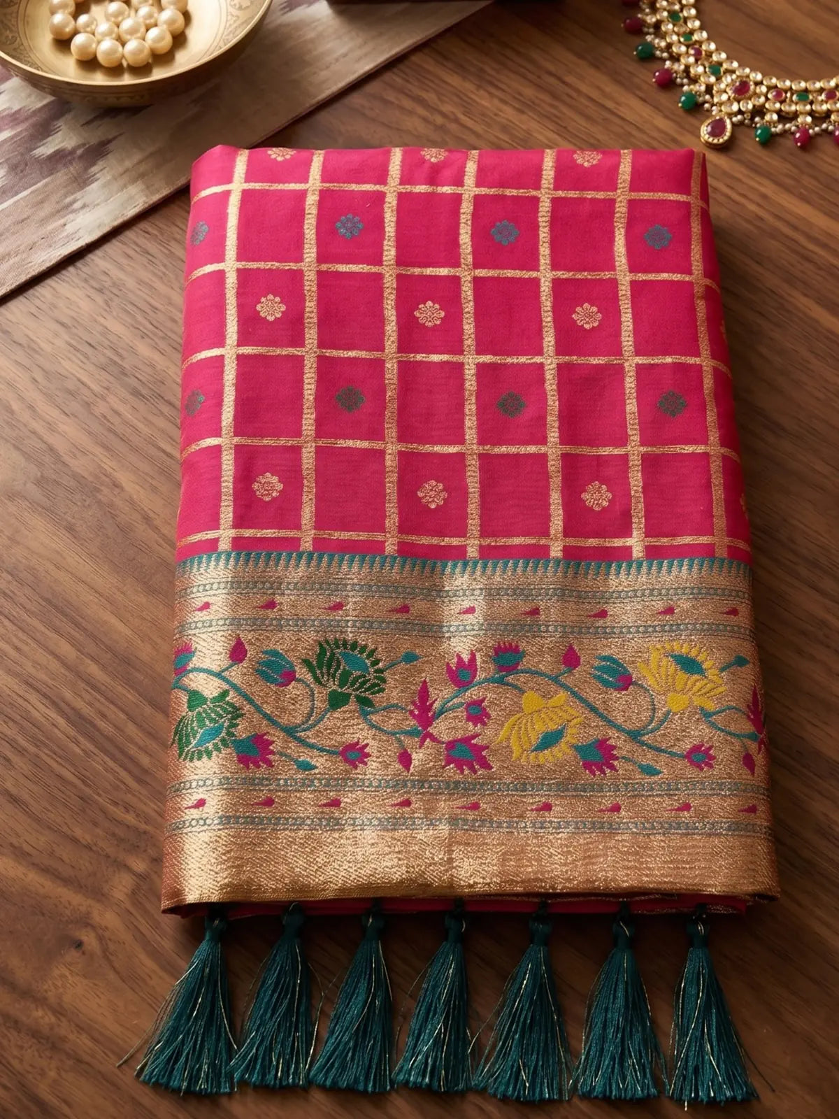 Tarani pink Banarasi silk saree folded fabric closeup with floral zari border
