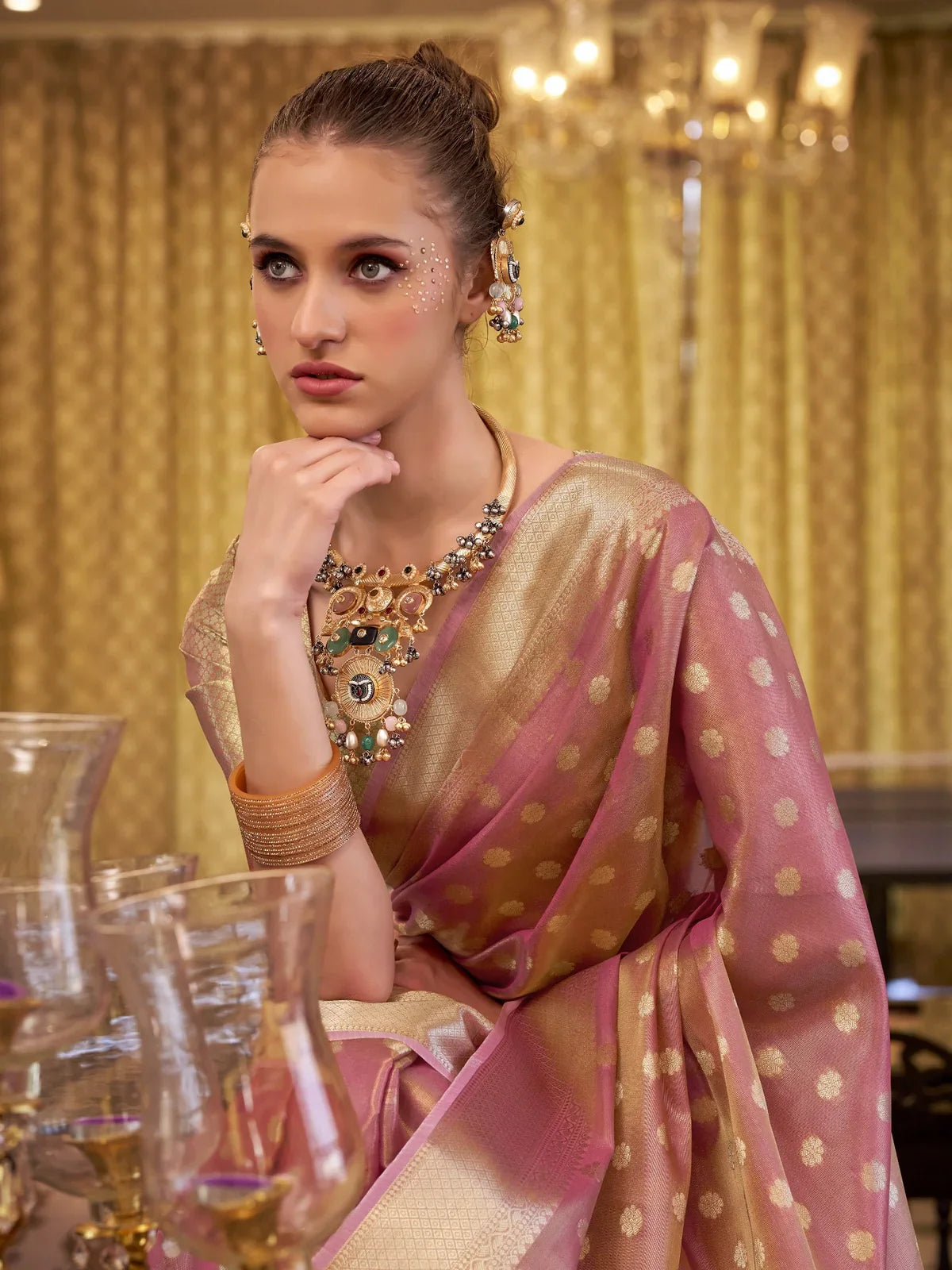 Tarani closeup of pink silk saree pallu and border showing woven zari motifs