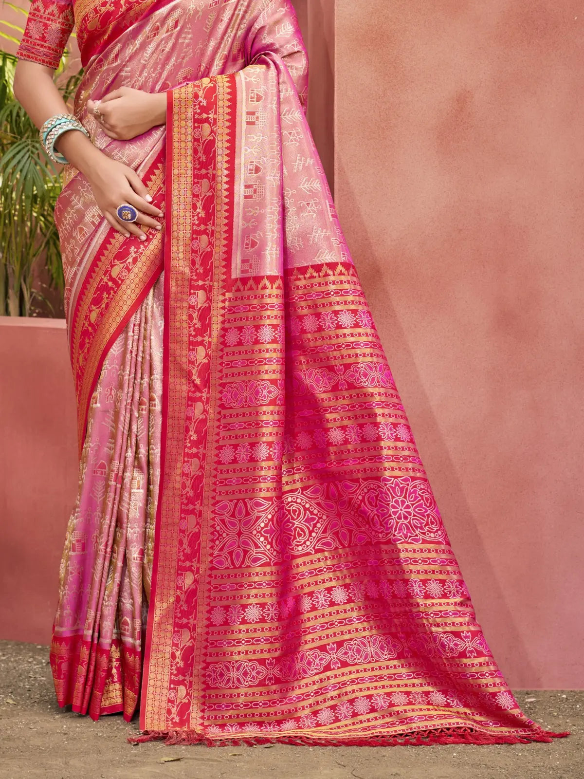 Tarani pink Kanjivaram silk saree pallu view highlighting intricate woven zari patterns