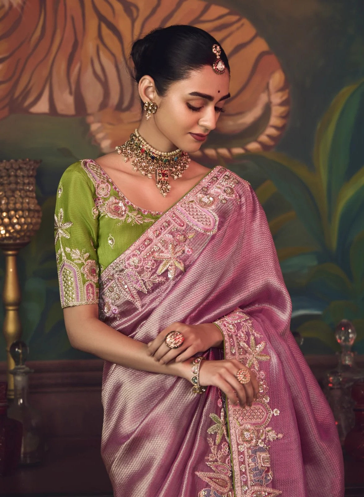 Tarani pink silk saree closeup showing upper body and neckline with green embroidered blouse