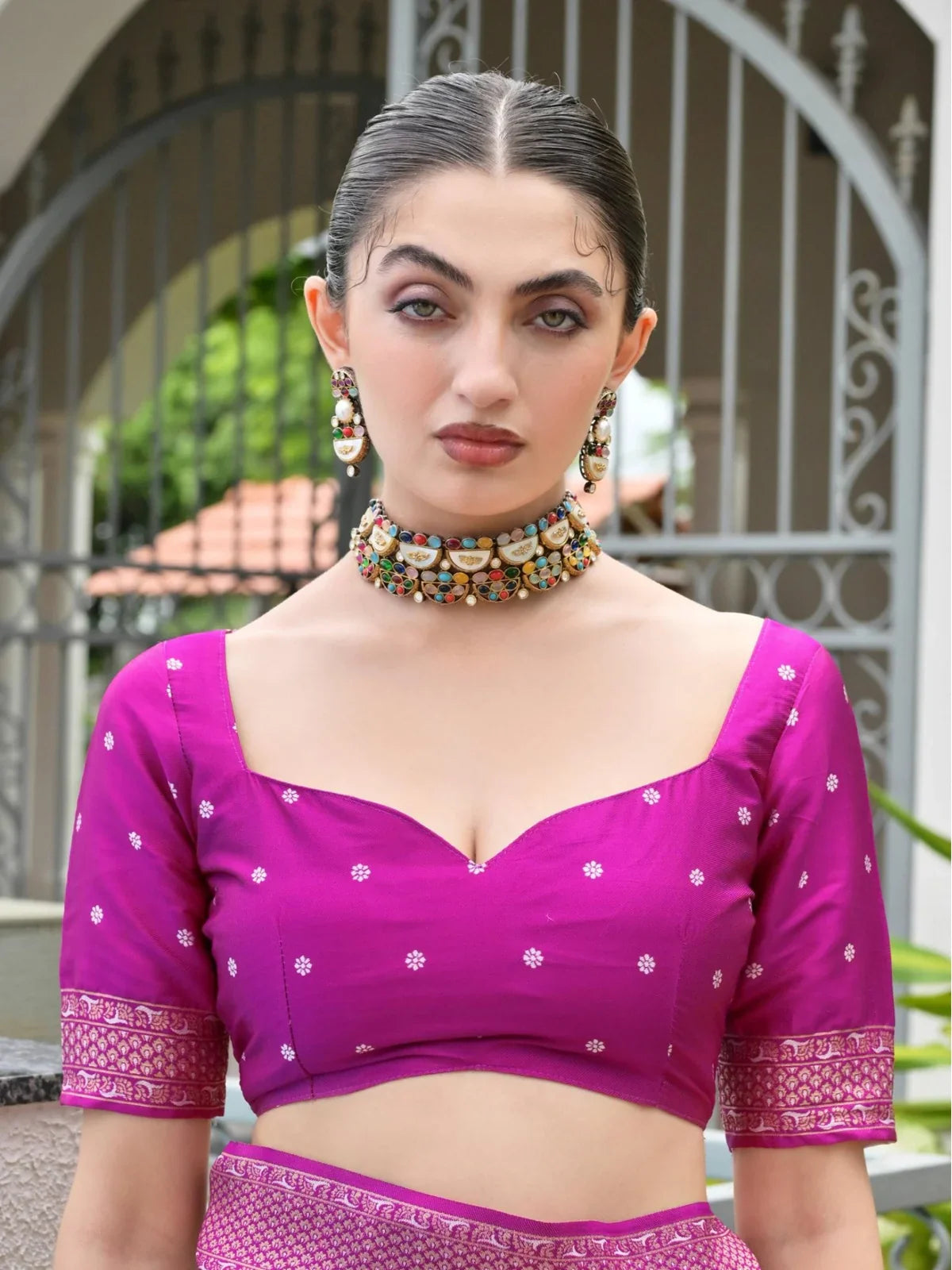 Tarani close-up of pink blouse with neckline and sleeve design paired with woven silk saree