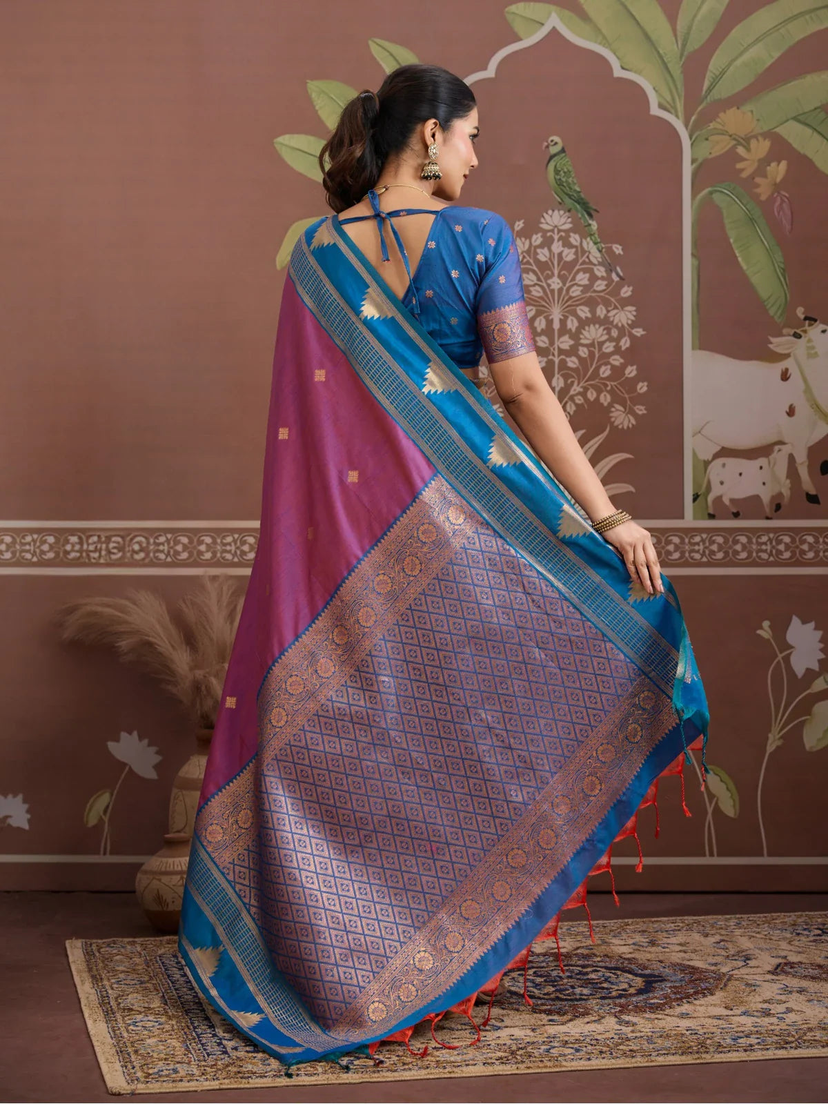 Tarani back pose of purple saree with contrast blue blouse and elegant pallu flow