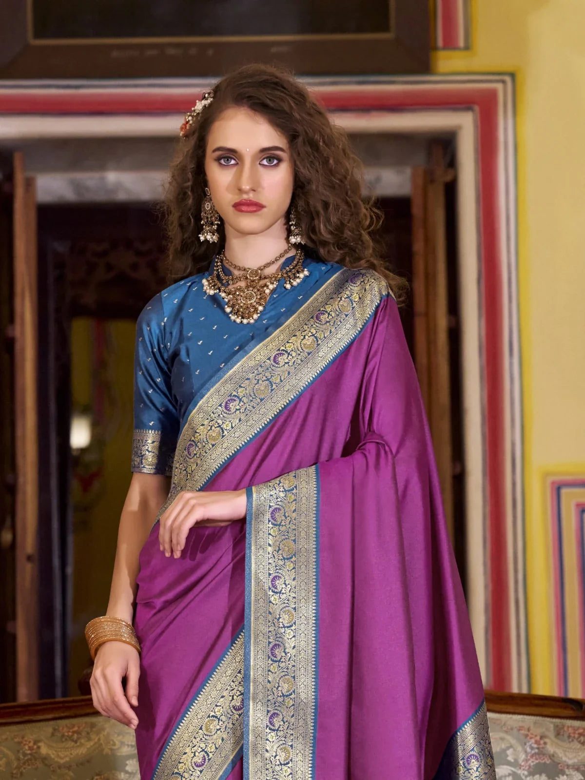 Tarani purple silk saree front view styled with blue blouse and elegant zari border