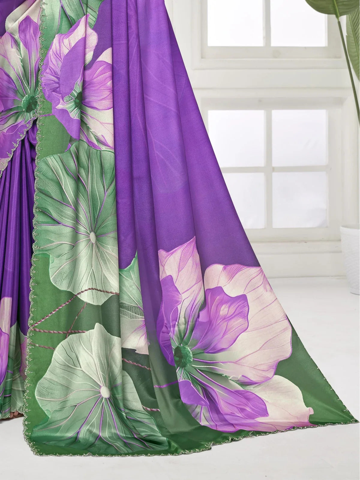 Tarani purple silk saree with green floral pallu and crystal work border close-up
